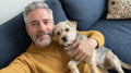 files/Man_holding_dog_on_sofa_202608262211_1.jpg